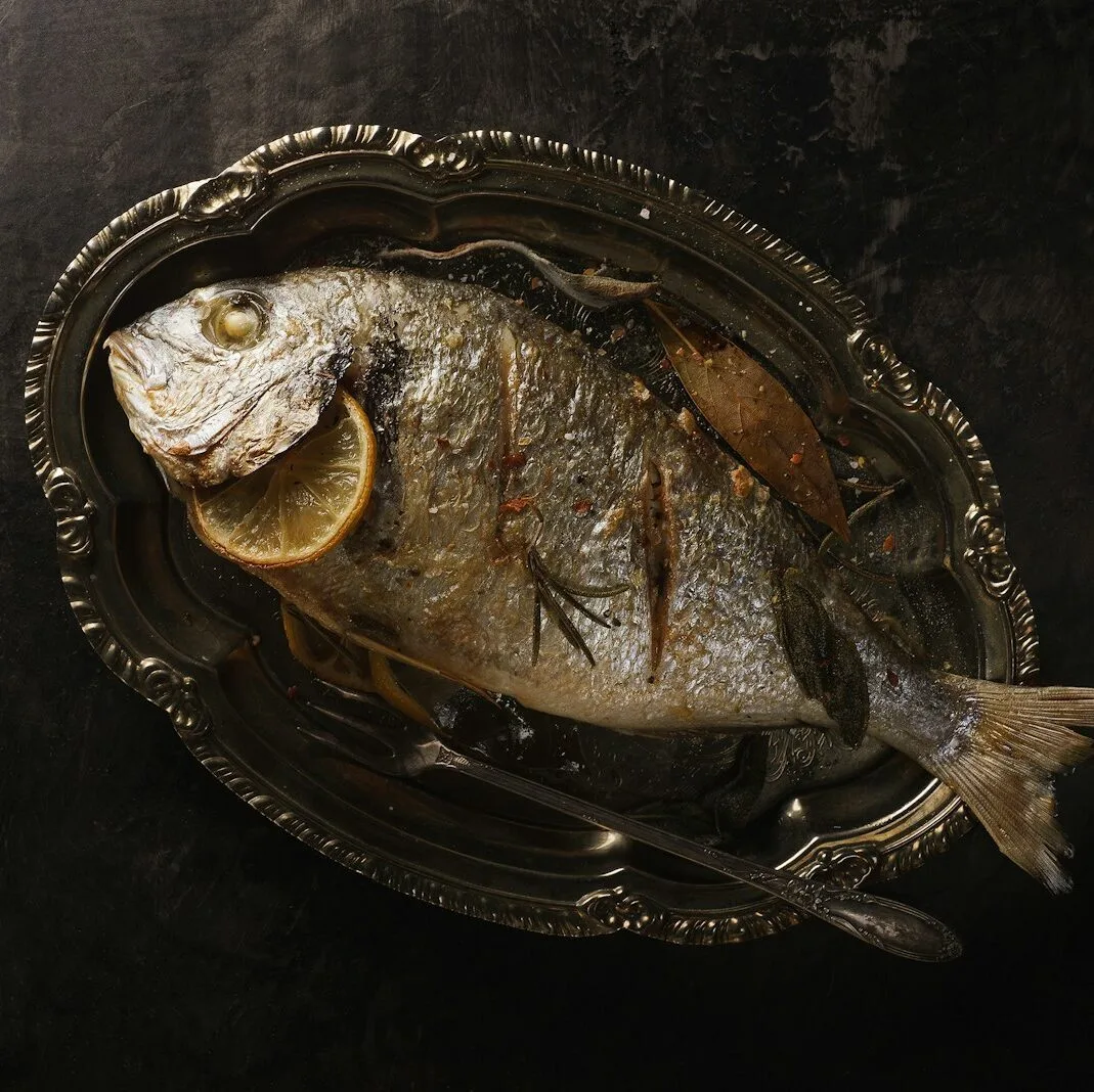 fried fish with lemon in plate